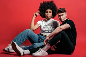 Multiethnic Prints: Multiracial couple studio shooting over a red background