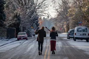 Colorado Prints: Musicians Ian Van Ornum (left) and Dani Aubert walk down a street in Boulder