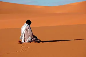 Arid Prints: Muslim man praying in the desert, Sebha, Ubari, Libya, North Africa, Africa