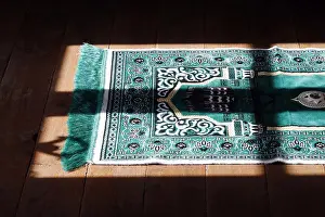 Interieur Prints: Muslim prayer mat at home. France. (Photo by: Pascal Deloche/Godong/UIG)
