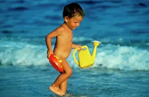 Seas Prints: Naked child playing at the seaside