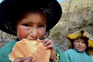 Looks Into The Camera Prints: Native Peruvian girl eating bread, portrait, Cusco, Peru, South America