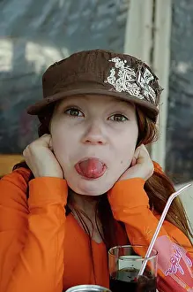 Beverage Prints: Naughty girl with cap sticking out her tongue, Corsica, France, Europe
