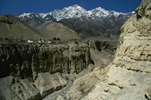 Nepalese Prints: Nepal, Mustang, Mountain Pass And Steep Sided Gorge With Snow Capped Mountain Peaks In The Distance