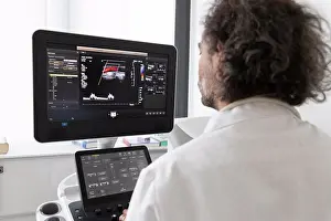 Electronics Prints: a neurologist gives an ultrasound to a patient