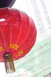 Tilted Prints: New building construction seen behind a red temple lantern, Chongqing, China