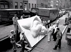 New York City Prints: New York, New York: 1940 Isamu Noguchi looking at part of the Associated Press Building Plaque