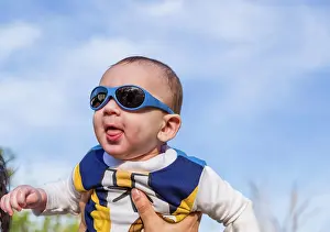 2015 Prints: Nice baby with blue googles Cute 6 months old baby with Light brown hair in white