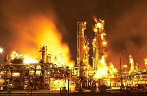 Oil Refinery Prints: Night view of fluid catalytic cracking unit at a petroleum processing facility