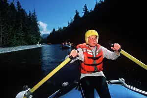 Paddle Prints: Nimpkish River Rafting - boy sweeps oars at helm
