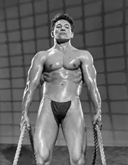 Bodybuilder Prints: Nude Bodybuilder Holds Ropes c.1950