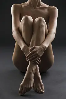 Nude female with legs crossed