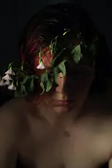 Soft Light Prints: nude woman sitting in dark room with flowers on her head
