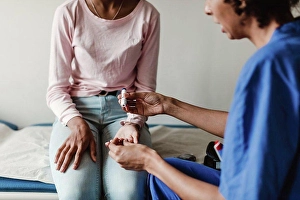 Doctors Prints: Nurse checking blood sugar of patient in medical examination room