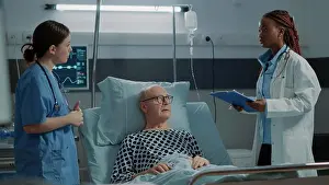 Oxygen Prints: Nurse checking oximeter on sick patient in hospital ward