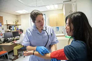Pulse Prints: Nurse examining a patient's arm for blood pressure and pulse