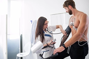 Connections Prints: Nurse performing ECG test on patient in consultation room