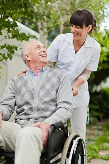 Handicapped Prints: Nurse wheeling older patient outdoors