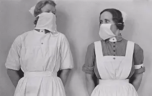 Precaution Prints: Nurses in the 1930s. Two woman in nurses uniform are wearing protective surgical masks on their faces
