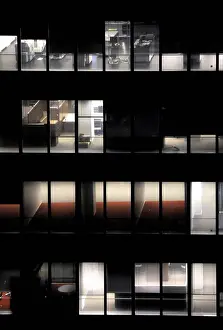 Crisis Prints: Office building showing an empty office for rent as a symbol of economic troubles at night