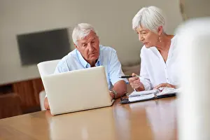 Paperwork Prints: Old couple, talking and laptop in home with paperwork