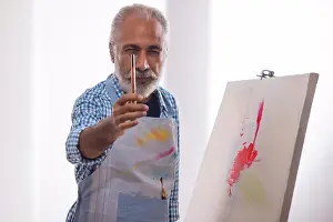 Smart Prints: AN OLD MAN POSING IN FRONT OF CAMERA WITH PAINTBRUSH IN HAND