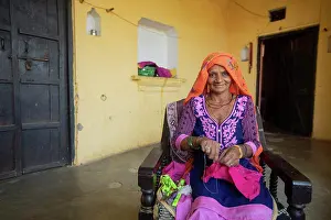 Livelihood Prints: old woman sewing cloth in her house, Rural India