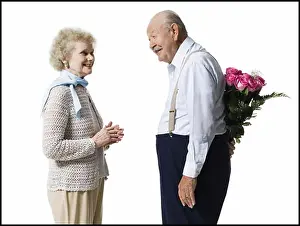 Model Release Prints: Older man with bouquet of pink roses behind back