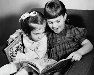 Braids Prints: Older sister explaining picture book to younger sister
