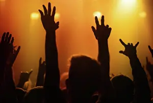 Live Prints: Orange lights, hands of people at concert or music festival dancing with energy in silhouette at live event
