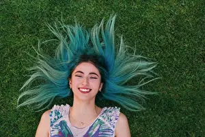 Individuality Prints: Overhead portrait carefree young woman with blue hair laying in grass