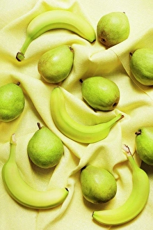 Wrinkled Prints: Overhead view of bananas and pears on yellow table cloth