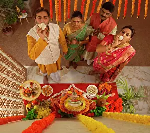 Occasion Prints: Overhead view of Maharashtrian family praying Lord Ganesha on the occasion of Ganesh Chaturthi