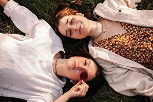 Lesbians Prints: Overhead view of two young women lying on grass