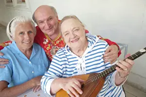 Folk Prints: Overseas visitors with musician in folk attire become best friends at a concert in the Inner Gardens of the Livadia