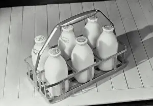 Beverage Prints: Six pack of milk bottles sitting on wooden surface
