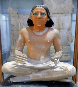 Limestone Prints: painted limestone statue of an Egyptian scribe seated cross-legged holding an open papyrus scroll
