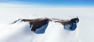 Antarctic Prints: Panoramic aerial view of the SANAE IV base on a mountain surrounded by snow in Antarctica