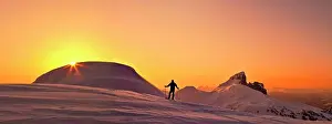 Hike Prints: Panoramic view of explorer on snowy mountain ridge at sunset