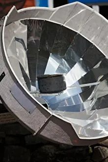 Nepal Prints: A parabolic solar water heater heats a bowl of water at Lukla