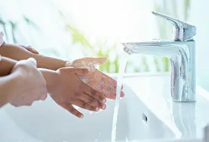Cleaning Prints: Parent, child and washing of hands in bathroom for cleaning