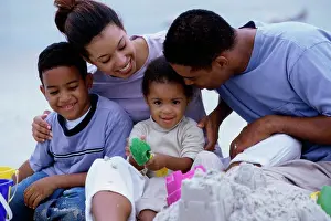 4 5 Years Prints: Parents with their son and daughter on the beach