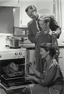 Father Prints: Parents and their son preparing a turkey in the kitchen