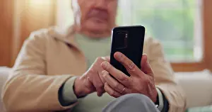 Disability Prints: Parkinsons, smartphone and hands of senior man typing online on internet search in retirement home