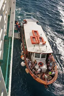 Boarding Prints: Passengers disembarking from a tender and boarding a cruise ship, Santorini, Greece