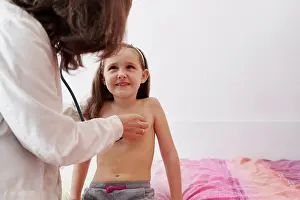 Physician Prints: Pediatric doctor examine little happy girl with stethoscope. Chi
