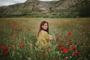 Red Hair Prints: Pensive attractive red haired adult lady in yellow dress with red poppy in hair