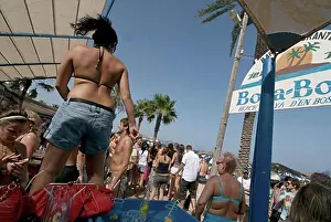 Coast Prints: People of all ages and type dancing non stop during the day at popular club Bora Bora in Playa d en Bossa Ibiza Spain