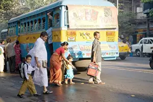 Traveling Prints: People crossing street behind blue bus ; Calcutta now Kolkata ; West Bengal ; India