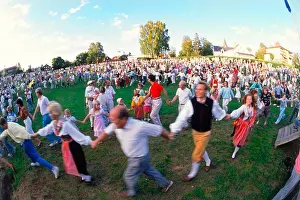 Circling Prints: People dancing around Maypole during Midsummer Celebrations at Leksand in Dalarna Sweden